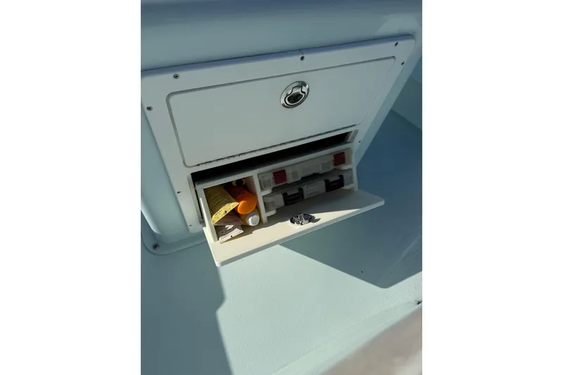 Slide: The Image of Storage compartment on a 2017 Sabalo 22 boat with organized items inside. - 15