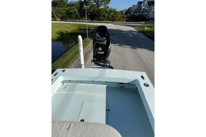 Slide: The Image of 2017 Sabalo 22 boat with Suzuki 140 engine on a residential street. - 16