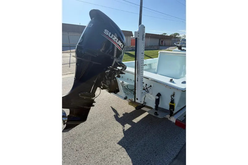 Slide: The Image of 2017 Sabalo 22 boat with Suzuki outboard motor, parked on pavement. - 18