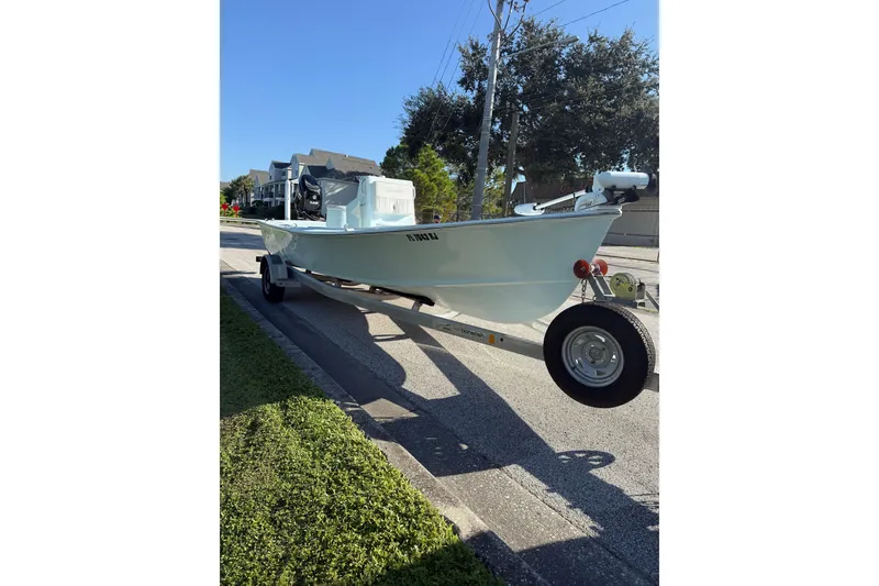 Slide: The Image of 2017 Sabalo 22 boat on trailer, parked on a residential street. - 21