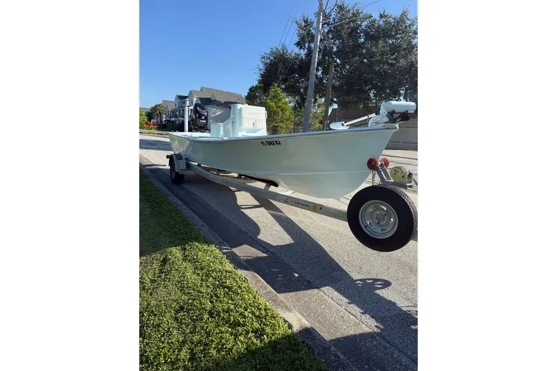 Slide: The Image of 2017 Sabalo 22 boat on trailer, parked on a sunny street. - 22