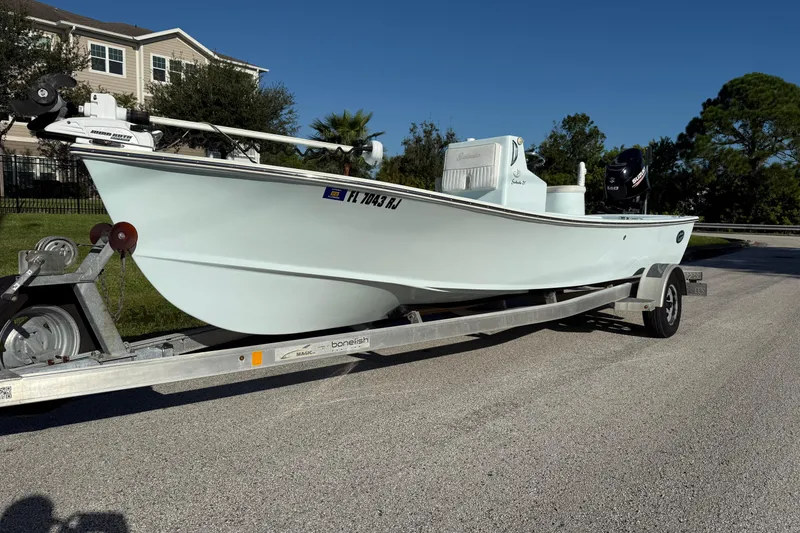 Slide: The Image of 2017 Sabalo 22 boat on trailer, parked on a sunny residential street. - 6