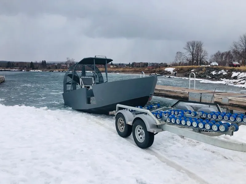 Slide: The Image of Duck Water Boats Airboat 23, 2022, on snowy riverbank. - 2
