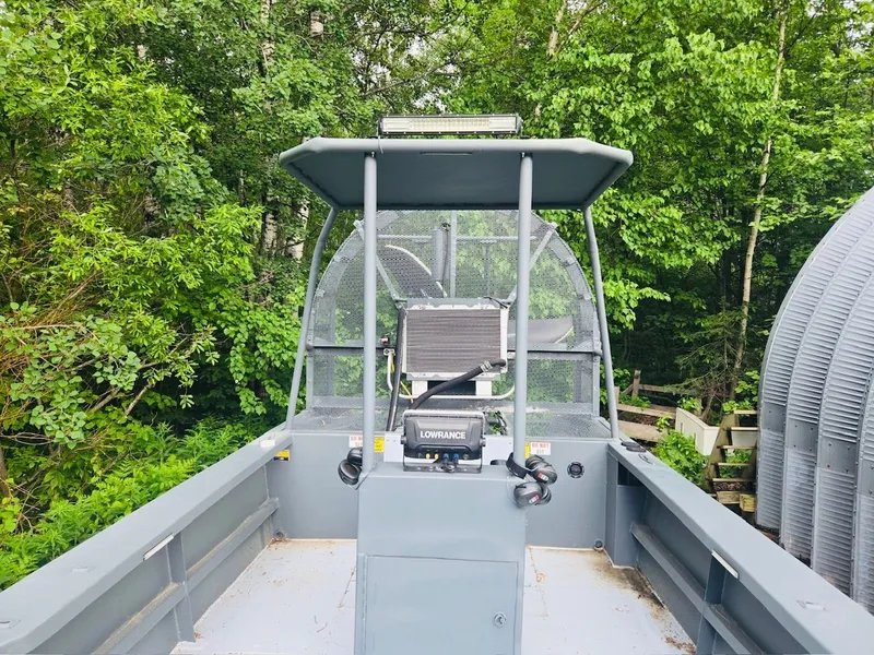 Slide: The Image of Duck Water Boats Airboat 23, 2022 model, parked in a forest. - 5