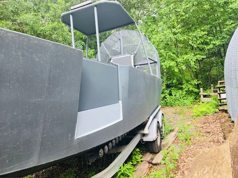 Slide: The Image of 2022 Duck Water Boats Airboat 23 parked in forest setting. - 7