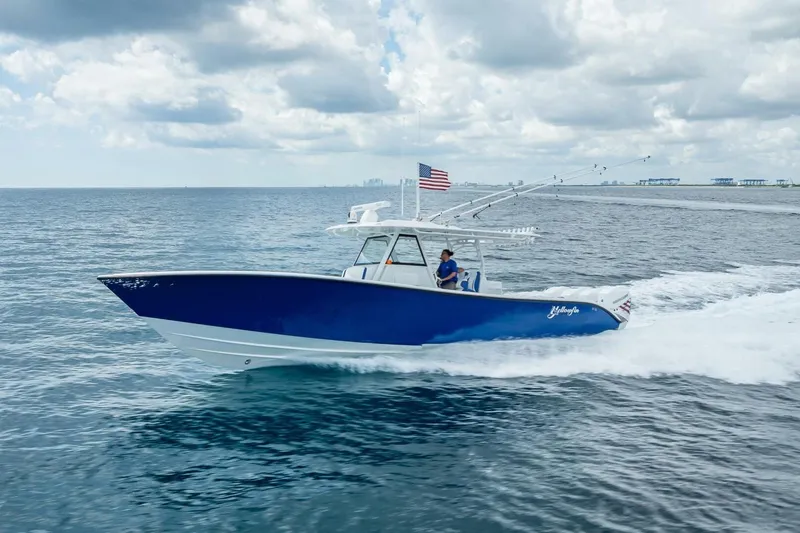 Slide: The Image of 2023 Yellowfin 39 Offshore boat cruising on open water under cloudy skies. - 22