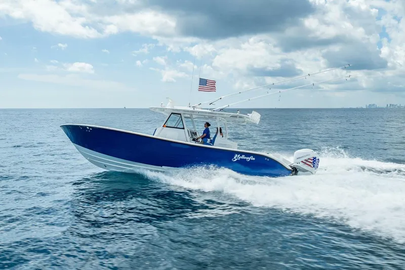 Slide: The Image of 2023 Yellowfin 39 Offshore boat cruising on open ocean under cloudy sky. - 24