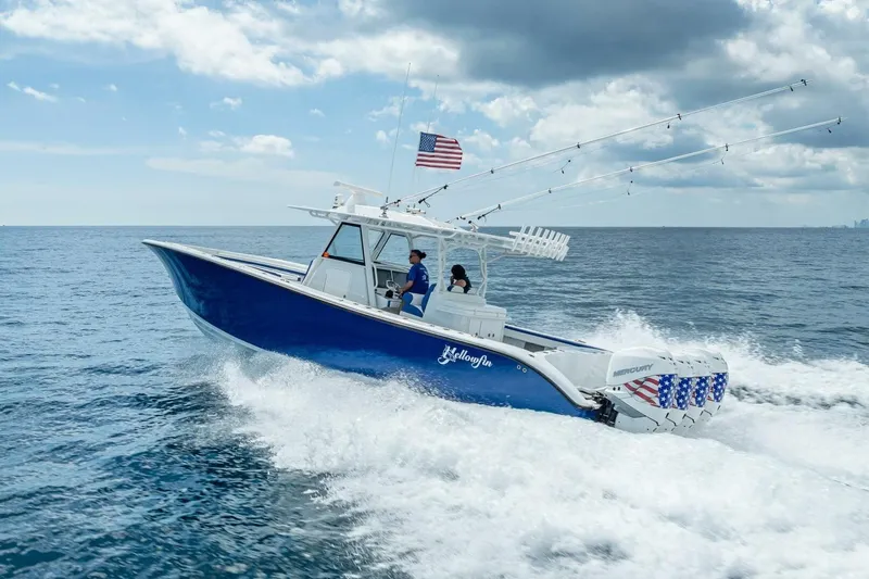 Slide: The Image of 2023 Yellowfin 39 Offshore boat cruising on open ocean under cloudy sky. - 25