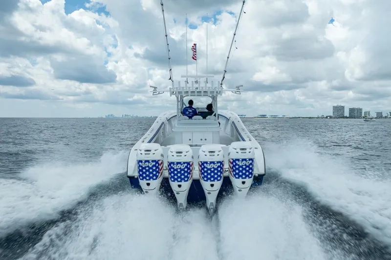 Slide: The Image of 2023 Yellowfin 39 Offshore boat speeding on open water under cloudy sky. - 29