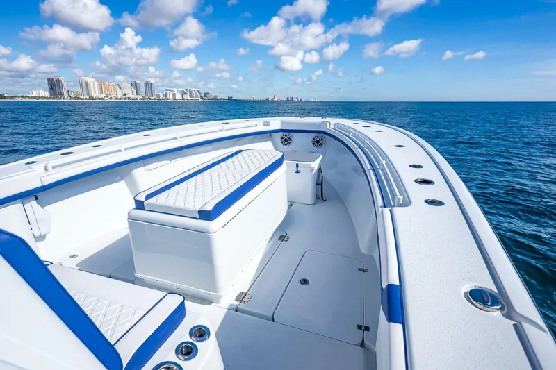 Slide: The Image of 2023 Yellowfin 39 Offshore boat on ocean, city skyline in background. - 39