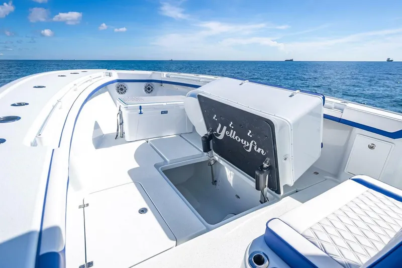 Slide: The Image of 2023 Yellowfin 39 Offshore boat interior with seating and storage, on a sunny ocean day. - 40