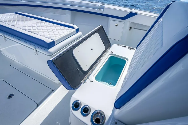 Slide: The Image of 2023 Yellowfin 39 Offshore boat interior with open storage compartment and cushioned seating. - 41