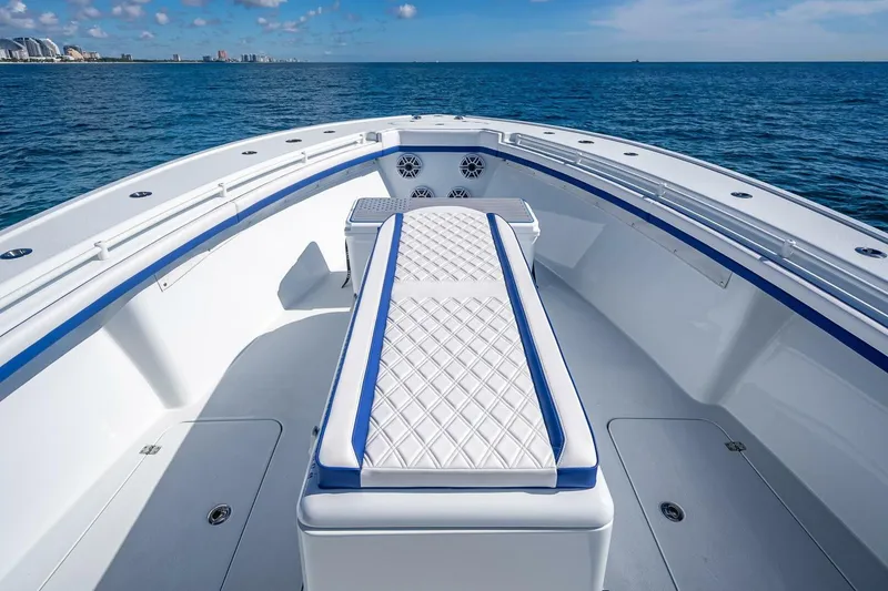 Slide: The Image of 2023 Yellowfin 39 Offshore boat interior with cushioned seating, ocean view. - 42