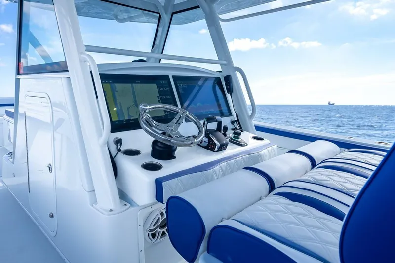 Slide: The Image of 2023 Yellowfin 39 Offshore boat cockpit with modern navigation system and ocean view. - 49