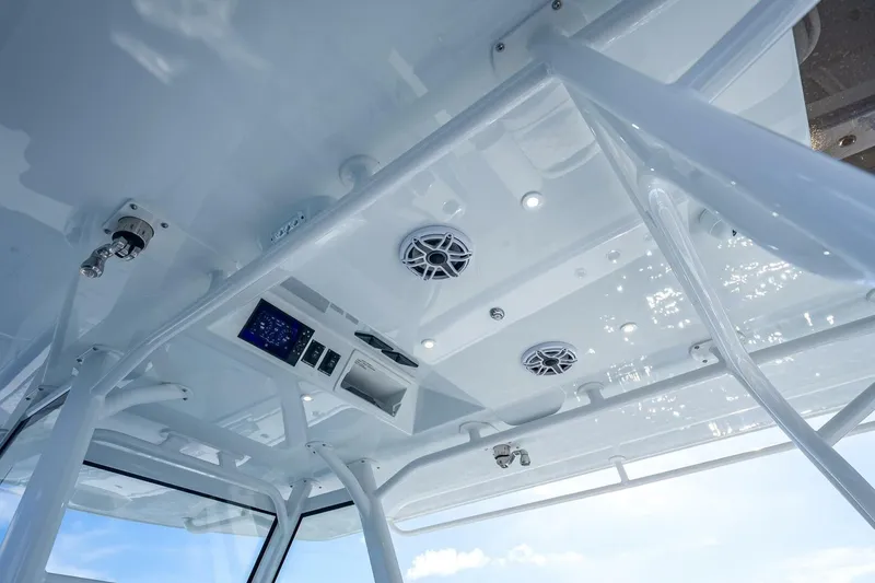 Slide: The Image of 2023 Yellowfin 39 Offshore boat interior ceiling with speakers and control panel. - 52