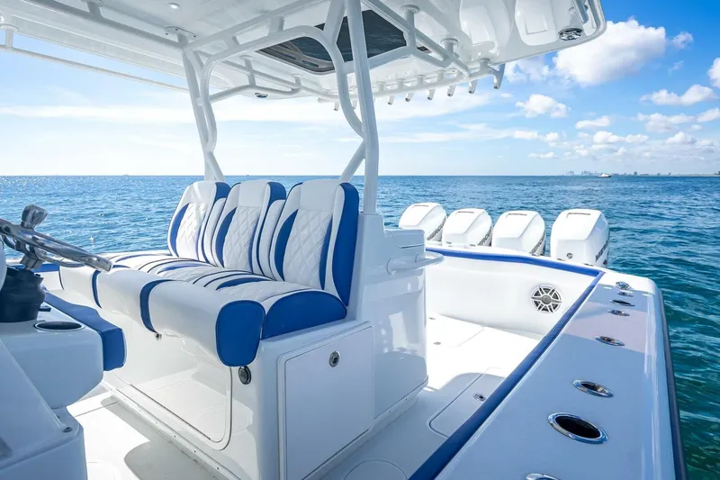 Slide: The Image of 2023 Yellowfin 39 Offshore boat interior with blue and white seating, ocean view. - 55