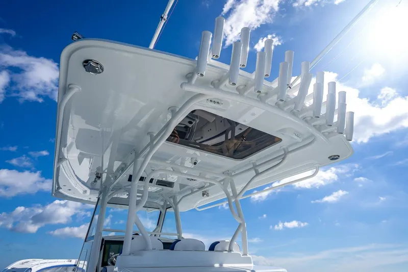 Slide: The Image of 2023 Yellowfin 39 Offshore boat with rod holders against a bright blue sky. - 61