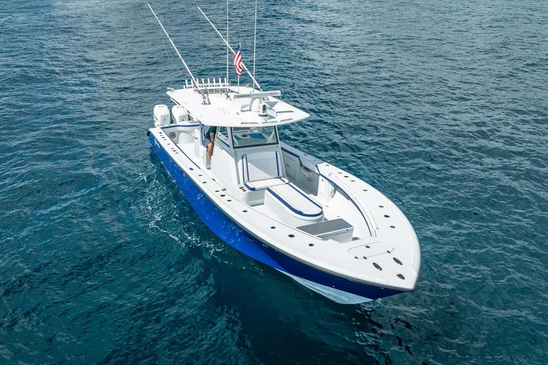 Slide: The Image of 2023 Yellowfin 39 Offshore boat cruising on clear blue ocean waters. - 9