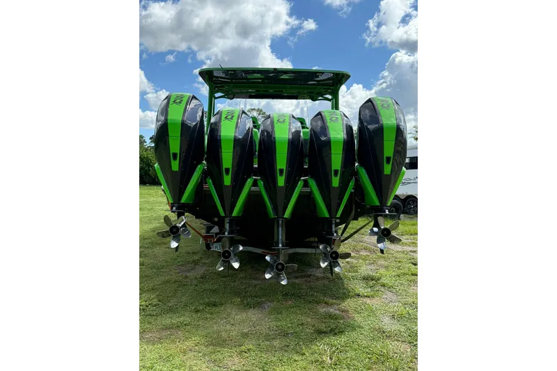 Slide: The Image of Five green outboard motors on a 2020 Midnight Express 43 Open boat. - 1