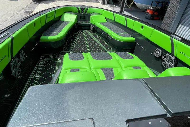 Slide: The Image of 2020 Midnight Express 43 Open boat with vibrant green seating and modern design. - 12