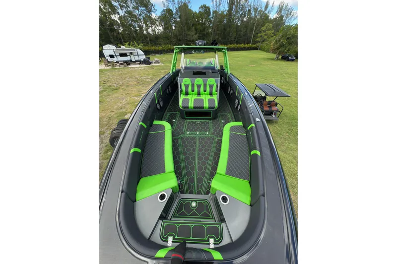 Slide: The Image of 2020 Midnight Express 43 Open boat with vibrant green and black interior design. - 15