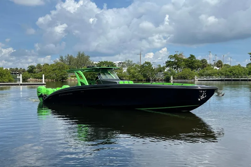 Slide: The Image of 2020 Midnight Express 43 Open boat with green accents on calm water. - 17