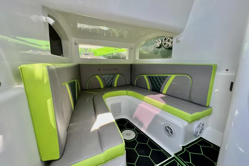 Slide: The Image of Interior of 2020 Midnight Express 43 Open boat with green and gray seating. - 20