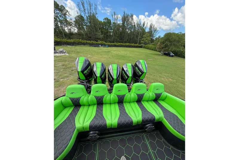 Slide: The Image of 2020 Midnight Express 43 Open boat with vibrant green seating and multiple outboard engines. - 4