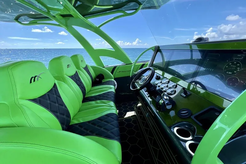 Slide: The Image of Interior of 2020 Midnight Express 43 Open boat with vibrant green seating and modern dashboard. - 6