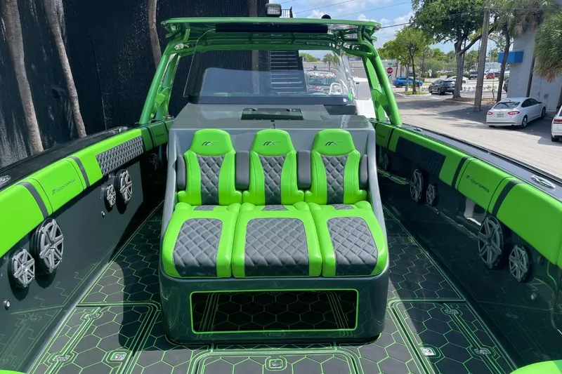 Slide: The Image of 2020 Midnight Express 43 Open boat interior with vibrant green and black seating. - 7