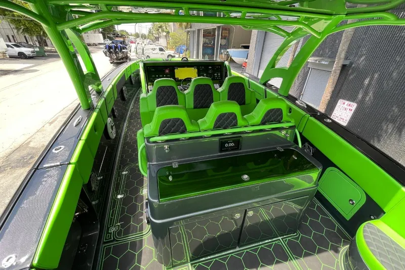 Slide: The Image of Interior of 2020 Midnight Express 43 Open boat with vibrant green accents and seating. - 9