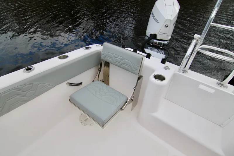Slide: The Image of 2024 Twin Vee 280 GFX CC boat interior with seating and Mercury outboard motor. - 10