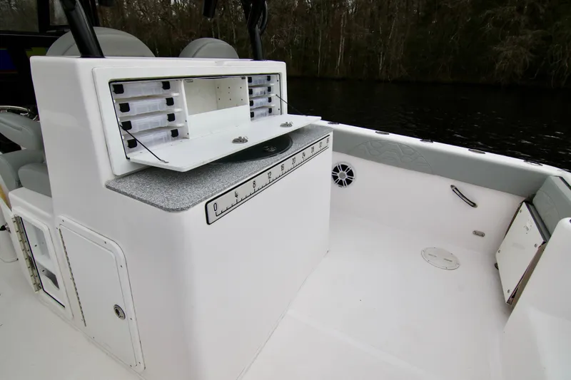 Slide: The Image of 2024 Twin Vee 280 GFX CC boat interior with storage compartments and seating. - 11