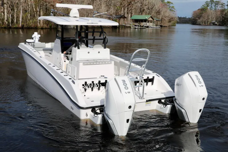 Slide: The Image of 2024 Twin Vee 280 GFX CC boat with dual engines on a calm river. - 3