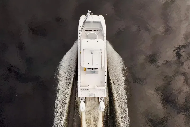 Slide: The Image of Aerial view of 2024 Twin Vee 280 GFX CC boat cruising on water. - 5