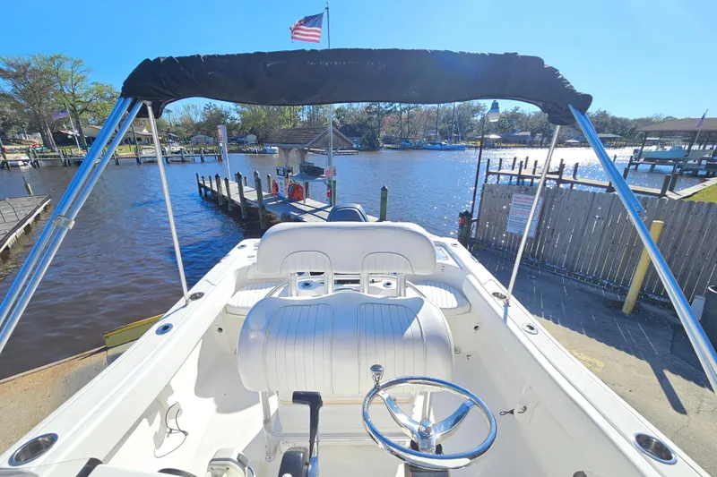 Slide: The Image of 2014 Sea Fox 199 Commander boat at dock, sunny day, American flag waving. - 10