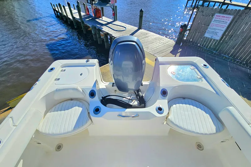 Slide: The Image of 2014 Sea Fox 199 Commander boat at dock, featuring spacious seating and motor. - 15