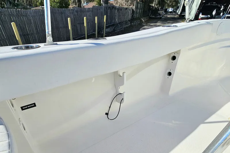 Slide: The Image of 2014 Sea Fox 199 Commander boat interior with raw water access and rod holders. - 17
