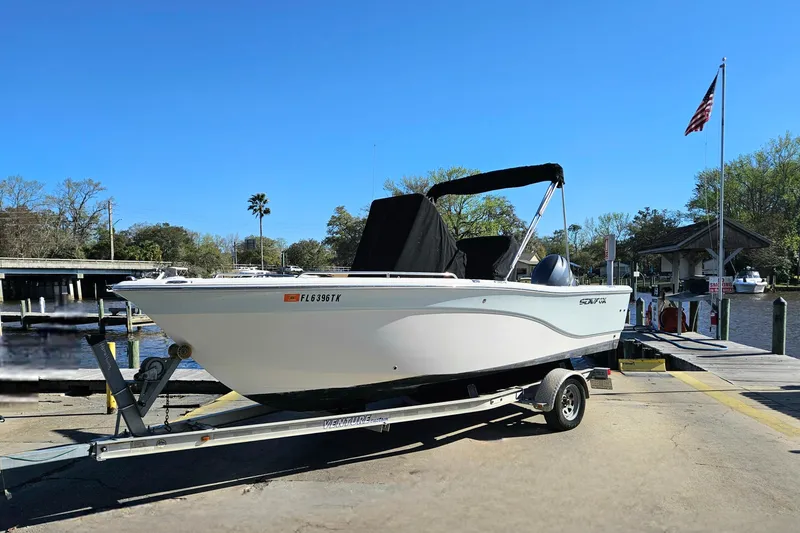 Slide: The Image of 2014 Sea Fox 199 Commander boat on trailer at dockside with clear blue sky. - 19