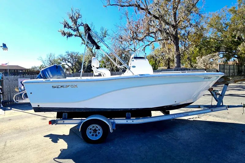 Slide: The Image of 2014 Sea Fox 199 Commander boat on trailer, parked outdoors. - 3