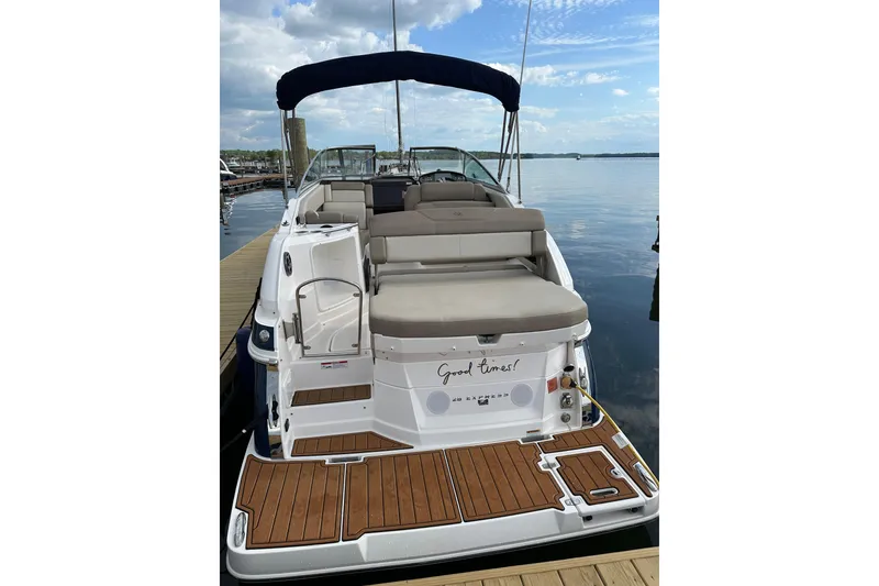 Slide: The Image of 2014 Regal 28 Express boat docked, featuring spacious seating and teak deck. - 18