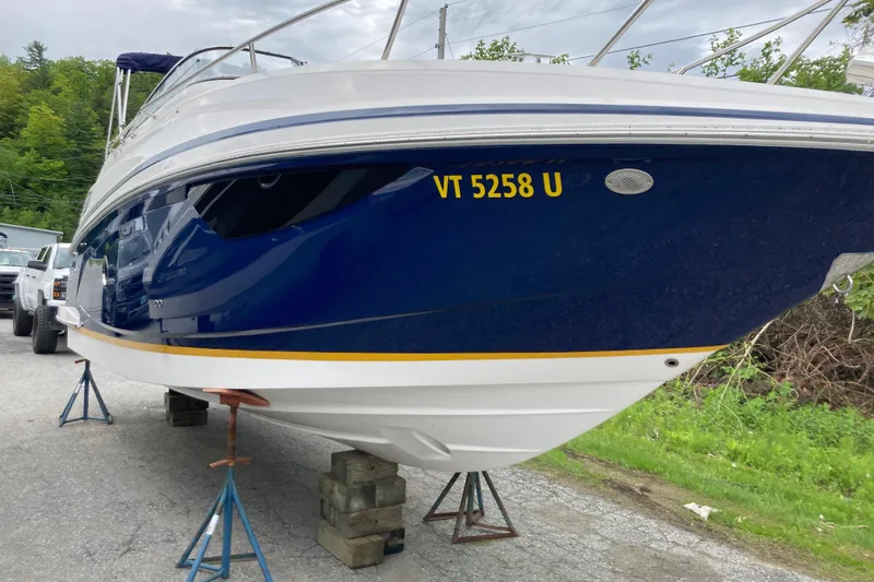 Slide: The Image of 2014 Regal 28 Express boat on stands, blue hull, registration VT 5258 U. - 21
