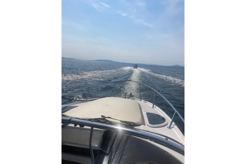 Slide: The Image of 2014 Regal 28 Express cruising on open water under clear skies. - 26