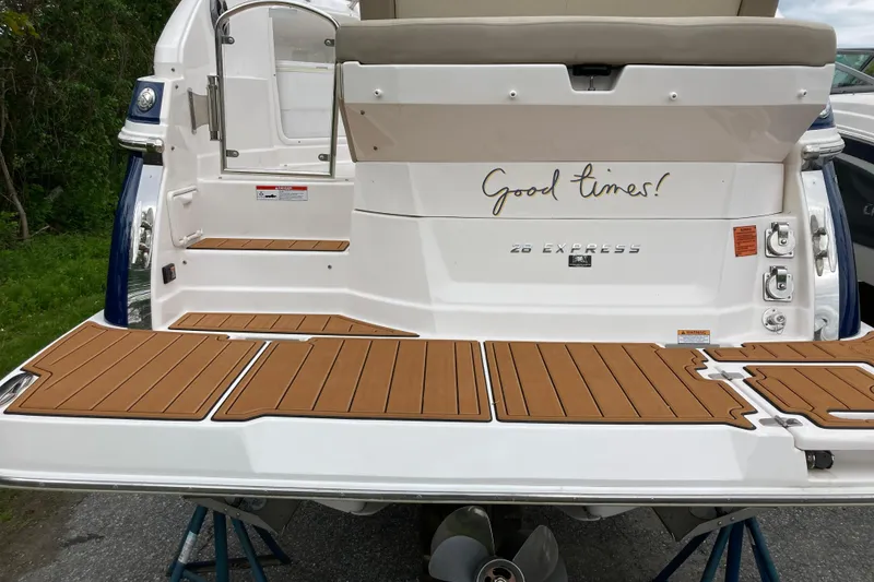 Slide: The Image of 2014 Regal 28 Express boat stern with "Good times!" text and teak-style decking. - 29