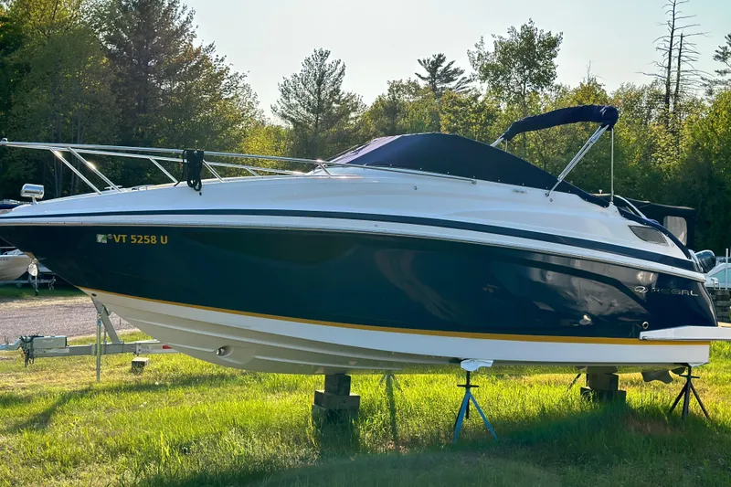 Slide: The Image of 2014 Regal 28 Express boat on stands, surrounded by trees. - 31