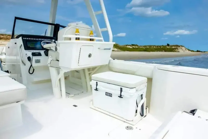 Slide: The Image of Manufacturer Provided Image: 2026 World Cat 265 DC-X boat interior with Yeti cooler, beach in background. - 5