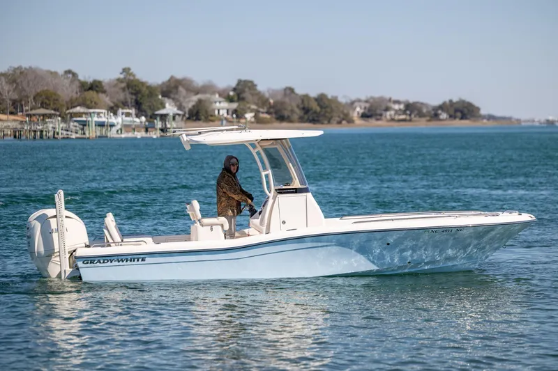 Slide: The Image of 2024 Grady-White 251 Coastal Explorer boat cruising on a serene waterway. - 10