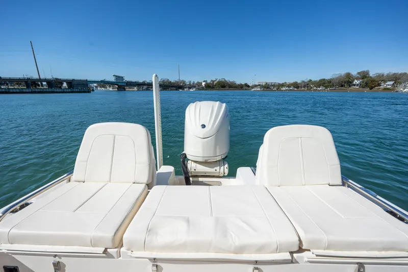 Slide: The Image of 2024 Grady-White 251 Coastal Explorer boat on calm water, featuring comfortable seating. - 13