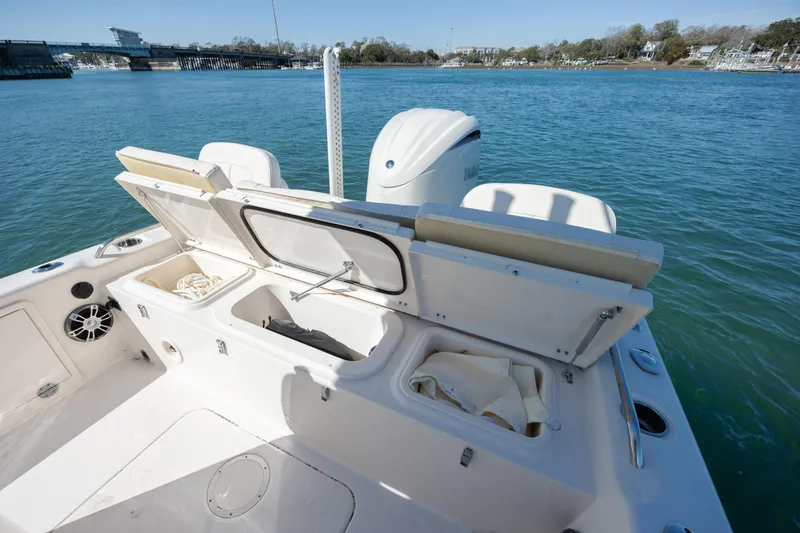 Slide: The Image of 2024 Grady-White 251 Coastal Explorer boat with open storage compartments on calm water. - 15