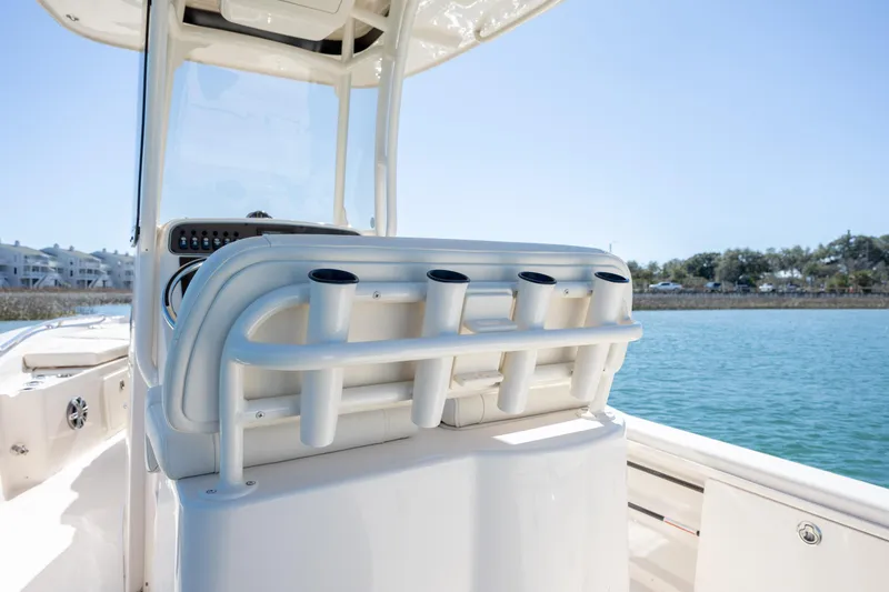 Slide: The Image of 2024 Grady-White 251 Coastal Explorer boat interior with rod holders, on calm water. - 18